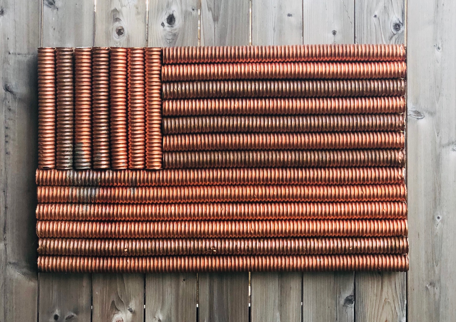 Copper-toned flag assemblage made from repeated ribbed forms