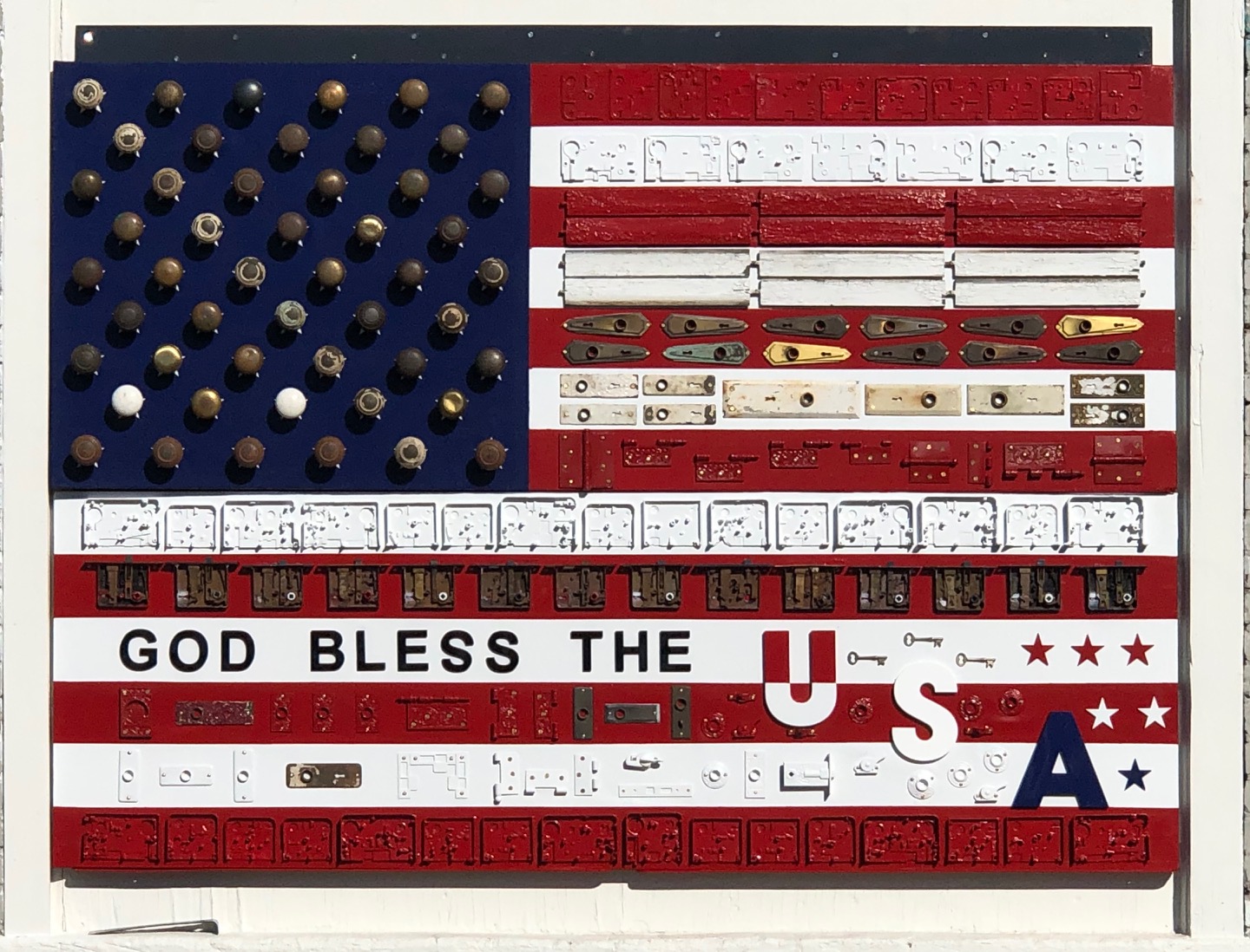 Assemblage flag work with found hardware, lettering, and red, white, and blue fields