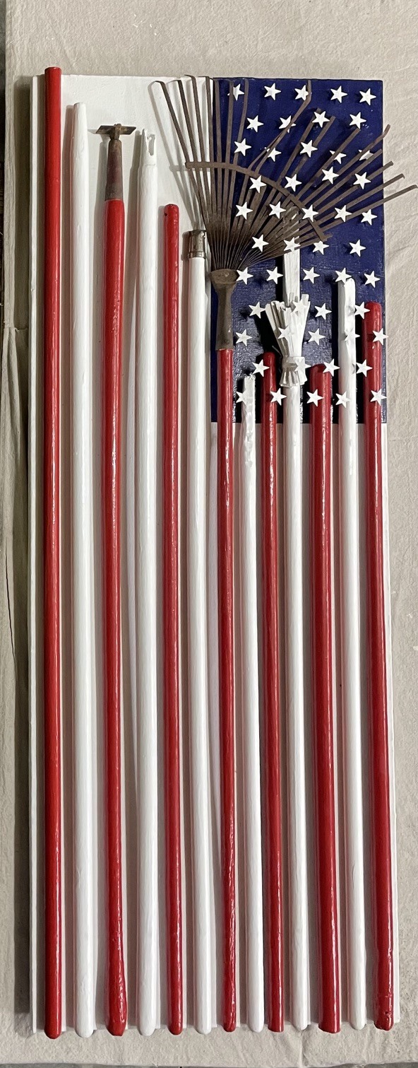 Vertical flag assemblage using red and white handles with tools and stars in the blue field