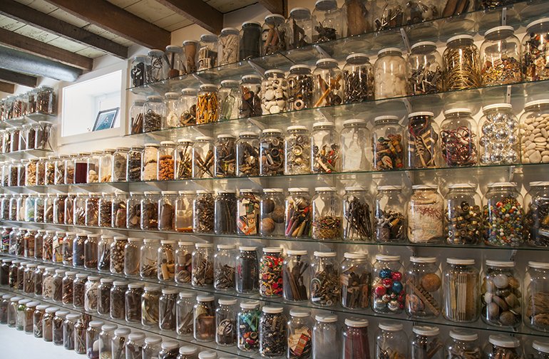 Shelves filled with jars of collected assemblage materials