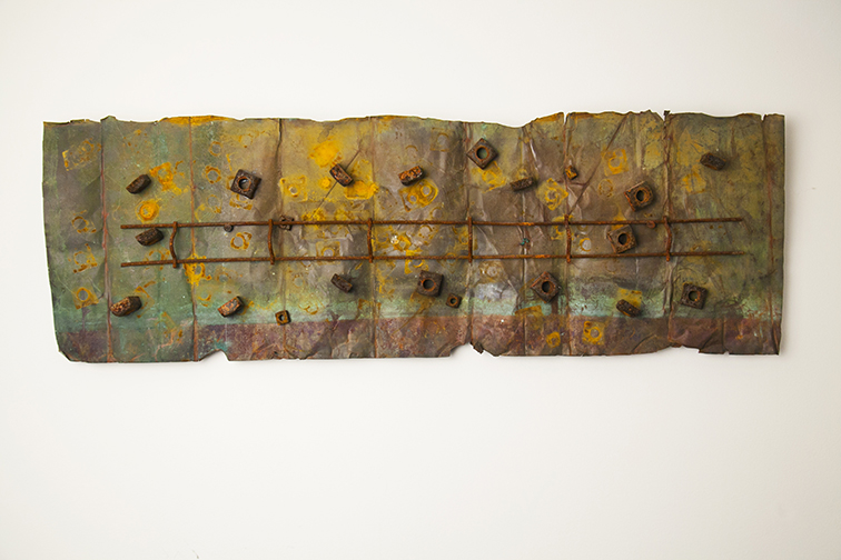 Long weathered assemblage with a rod and repeated small rusty forms
